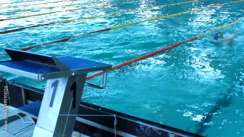 Teenage Competition in Swimming pool race in the tracks,indoor swim pool photo