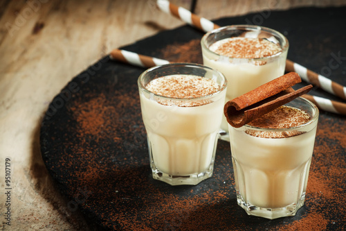 Traditional winter eggnog  with milk, rum and cinnamon, sprinkle #95107179