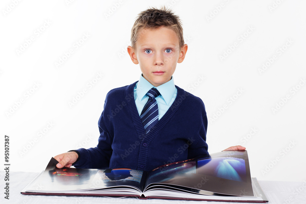 Preschooler boy is wearing business clothes with book Preschooler boy is wearing business clothes with book