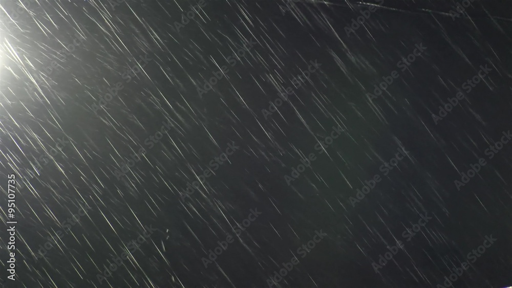 Heavy storm rain in dark night lit 