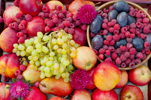 Fototapeta Naklejka Na Ścianę i Meble -  different types of fruit and raspberry closeup with flower aster