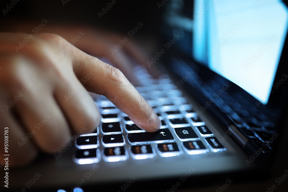 Hands typing on laptop computer