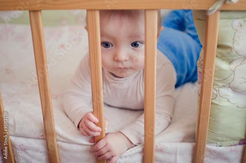 Sad baby in the crib