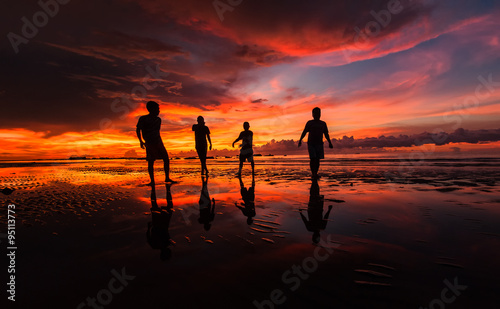 A group of man walking along the coast