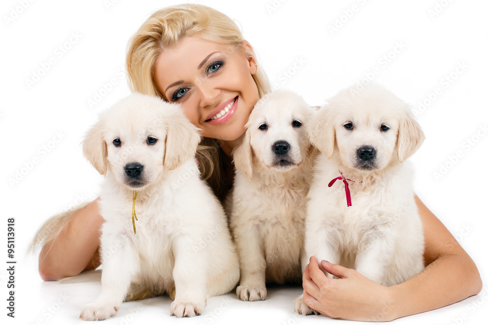 Beautiful blonde with a small white puppy of Labrador Beautiful blonde with a small white puppy of Labrador
