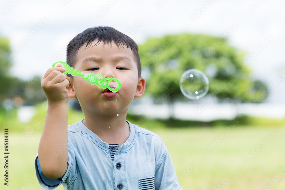 Cute boy blowing a soap bubbles Cute boy blowing a soap bubbles