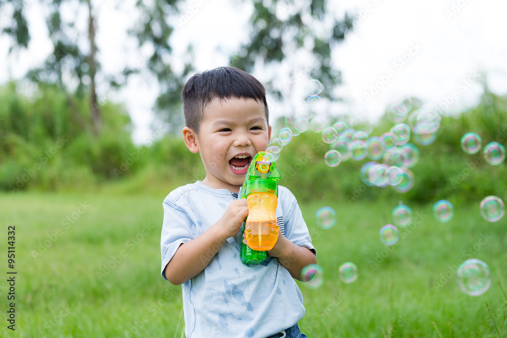 Excited little boy play with bubble gun Excited little boy play with bubble gun