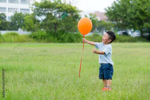 Cute boy play with balloon at outdoor