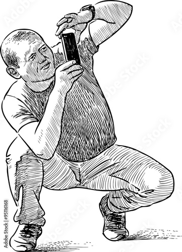 person takes picture at a cell phone