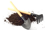 garden spade and a rake on peat soil separately on a white backg