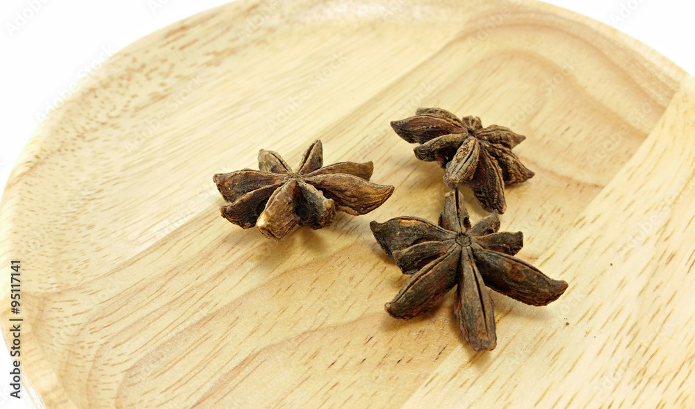 star anise on wooden plate star anise on wooden plate
