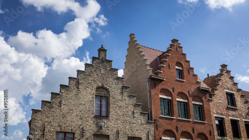 Stepped House Gables in Bruges, Belgium with Blue Sky and White Clouds © brandtbolding