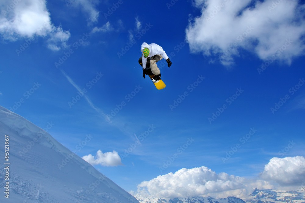 snowboarder in green and white performing a jump