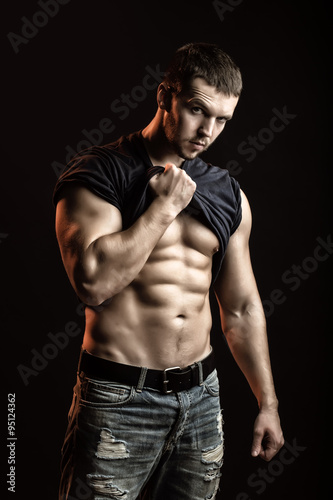 Obraz na płótnie Muscular man with shirt on shoulder w salonie