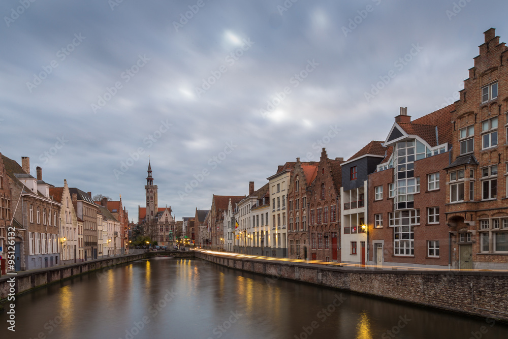 North of the Markt at Briges with church, traditional houses and moving clouds, Bruges, Belgium