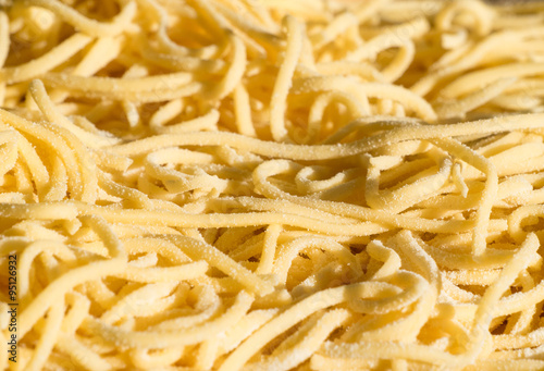 Extreme close up detail of home made spaghetti, with flour on surface