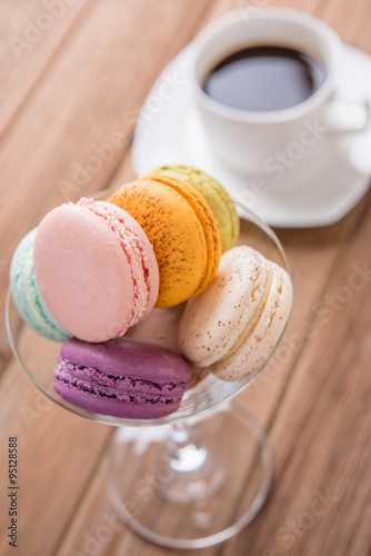 mix macaron on tge wooden table with coffee photo