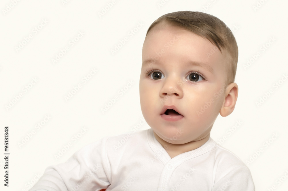 Cute baby boy looking surprised. Adorable baby portrait looking curious isolated on white.