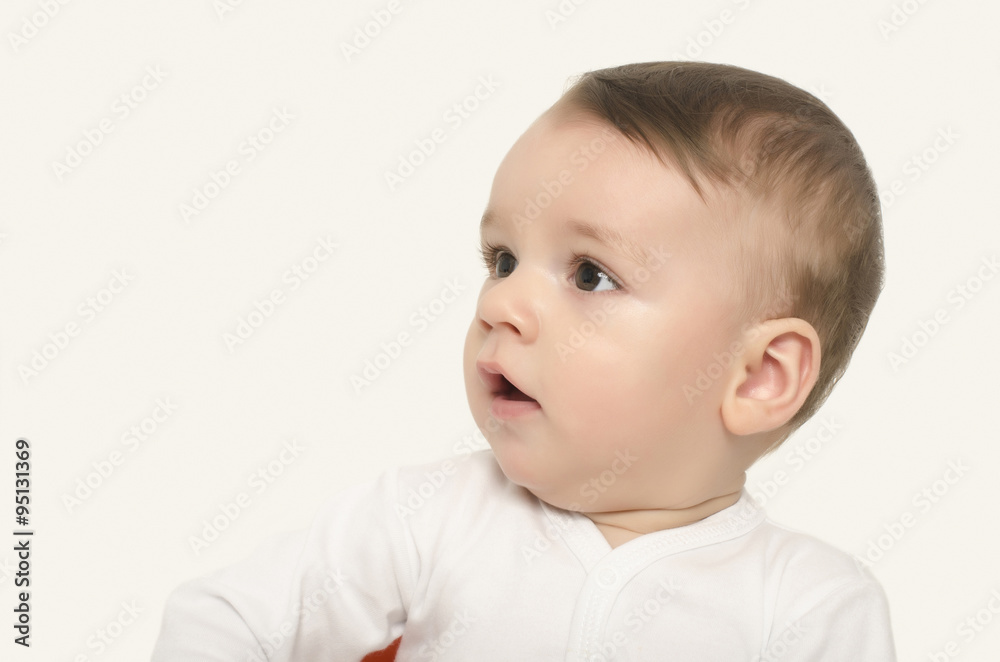 Cute baby boy looking to the side surprised. Adorable baby portrait looking curious isolated on white.
