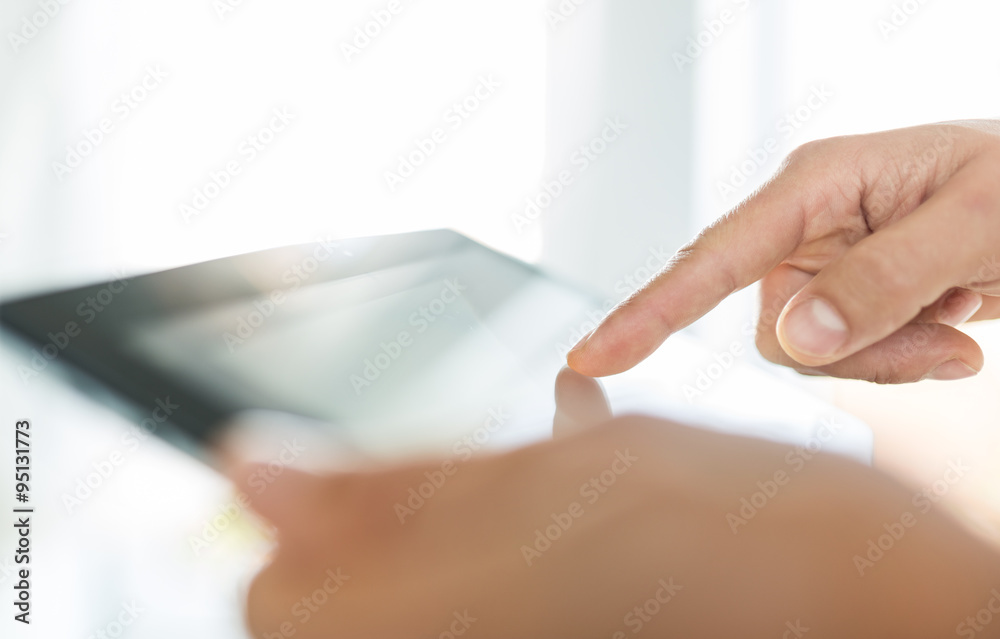 Man hand touching screen on modern tablet pc. Close-up image wit