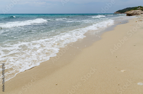 Sea shore view with white waves and sand © bogdanvija
