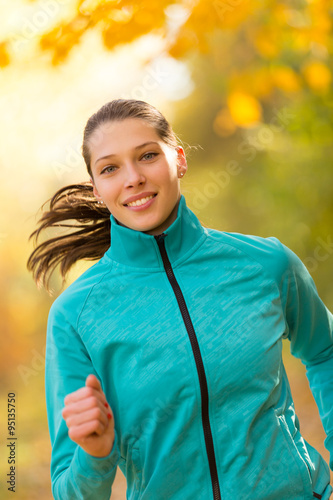 Female fitness model training outside and running. © Jag_cz