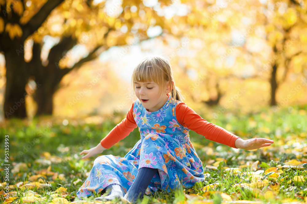 Autumn fun. Little girl playing in autumn cherry trees garden. Autumn fun. Little girl playing in autumn cherry trees garden.