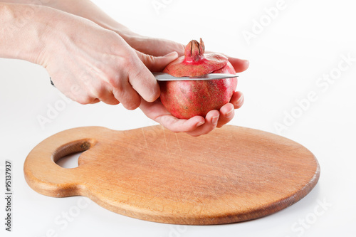 Chef cuts and cleans pomegr...