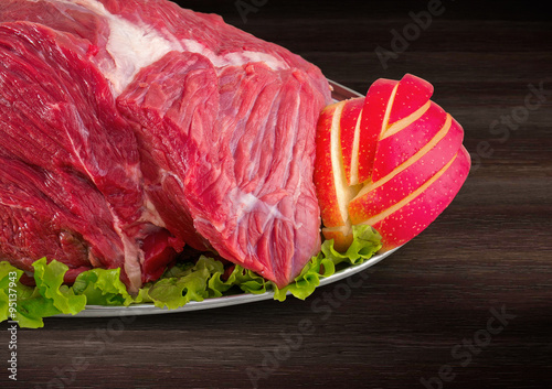 Detail of decorated fresh raw meat - ham with vegetables with cl
