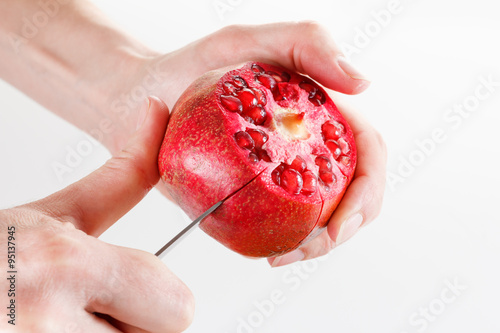 Chef cuts and cleans pomegr...