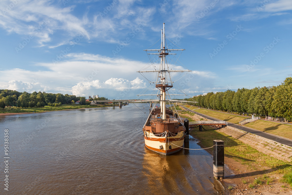 Summer landscape on the river in the city on a sunny day with a stylized ancient ship-landing-stage. Veliky Novgorod on the Volkhov River in Russia Summer landscape on the river in the city on a sunny day with a stylized ancient ship-landing-stage. Veliky Novgorod on the Volkhov River in Russia