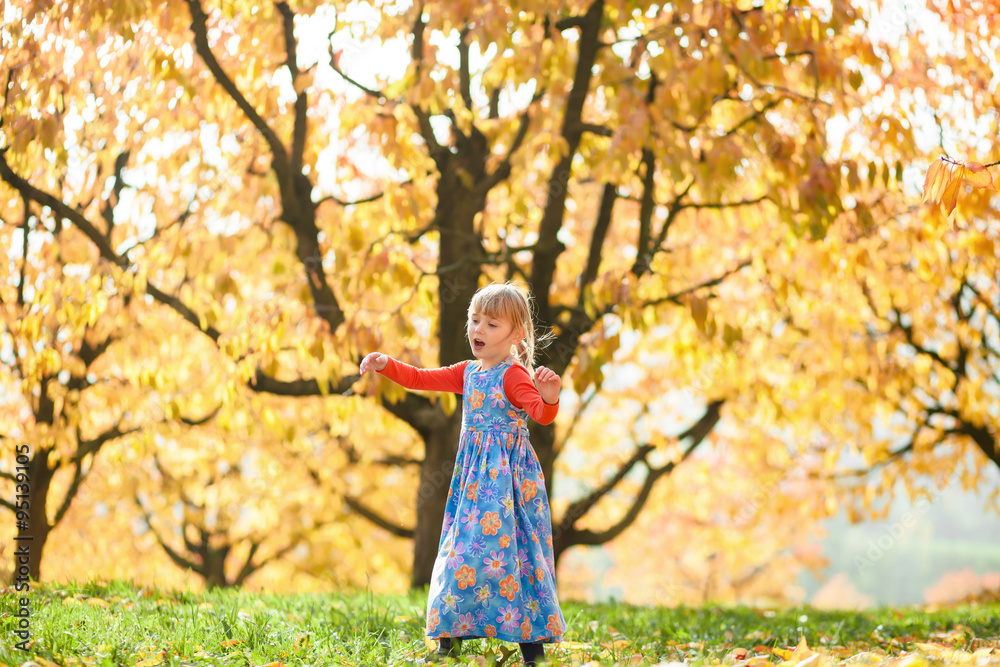 Autumn fun. Little girl playing in autumn cherry trees garden. Autumn fun. Little girl playing in autumn cherry trees garden.