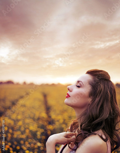 Beautiful woman on summer flower meadow © konradbak