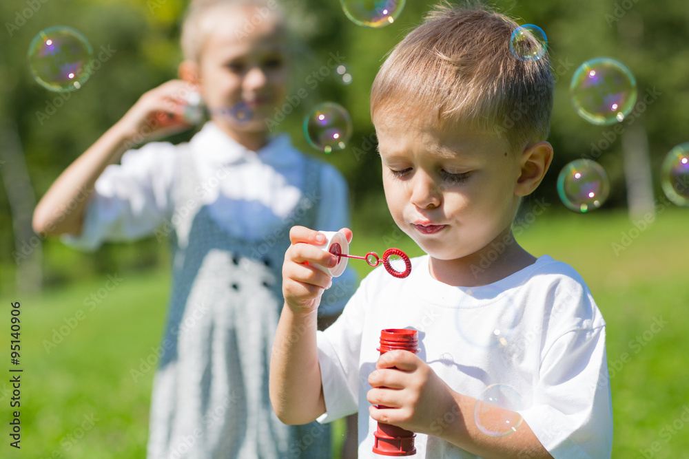 Happy children blow soap bubbles Happy children blow soap bubbles