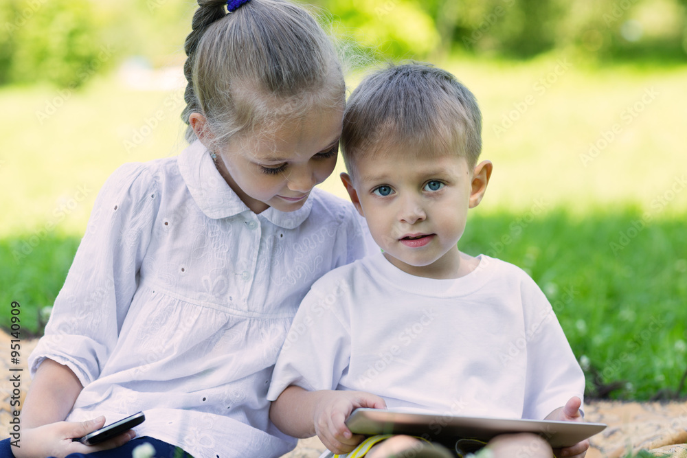 Children using a tablet PC and smartphone Children using a tablet PC and smartphone