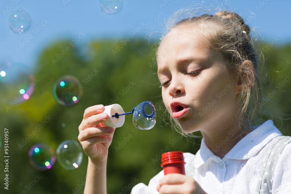 Cute little girl blowing soap bubbles Cute little girl blowing soap bubbles