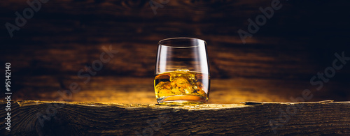 Obraz na plátne Whiskey glass on the old wooden table