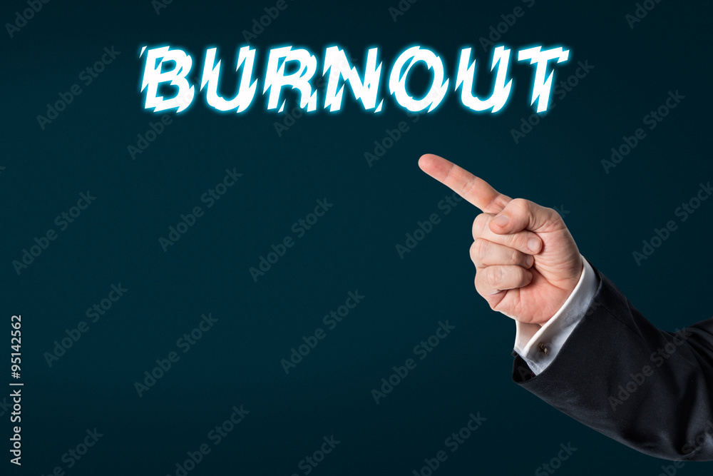 Business man pointing at the words burnout Business man pointing at the words burnout