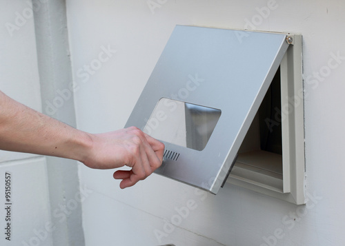 man's hand open the post box