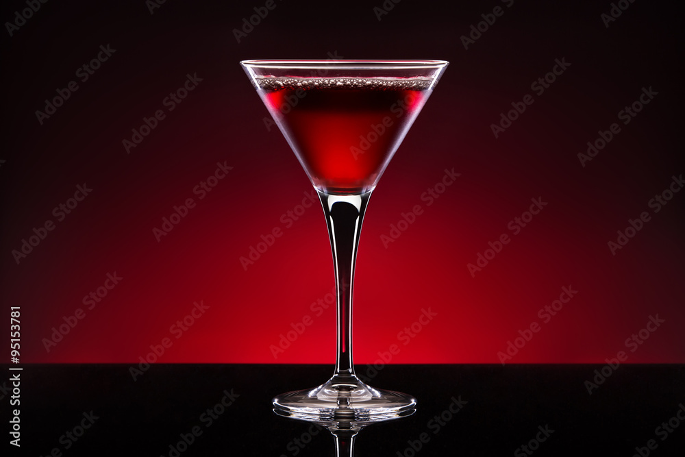 Cherry cocktail in a crystal glass isolated on red black backgro