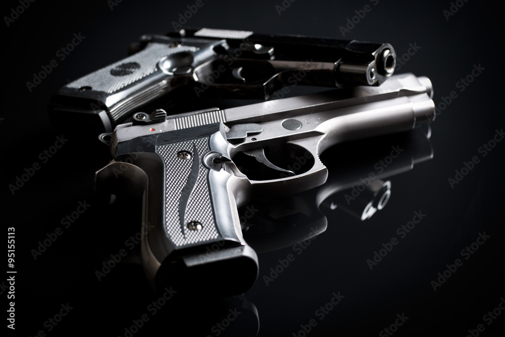 handguns on black background