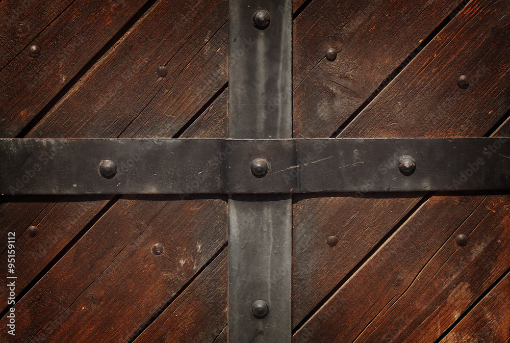 The metal strip on the wooden background