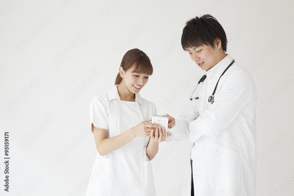 Doctors and nurses are looking at mobile phone Doctors and nurses are looking at mobile phone
