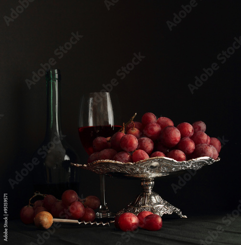 Red grapes and glass of wine