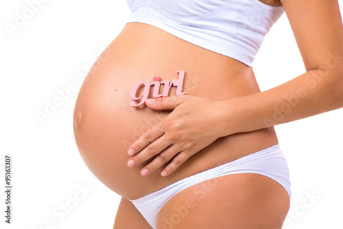 Wallpaper Mural Close-up of pregnant tummy with pink label "Girl" for newborn daughter on  horizontal white background Torontodigital.ca