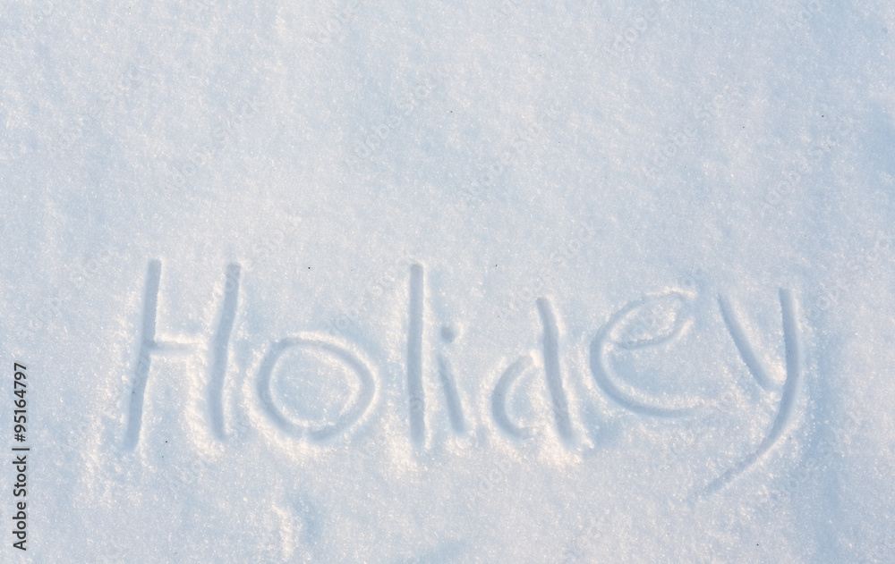 The word Holiday draw on snow The word Holiday draw on snow