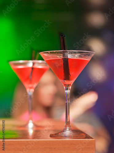 Two glasses with red cocktail on the table