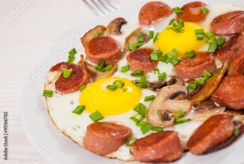 fried eggs with mushrooms and sausage