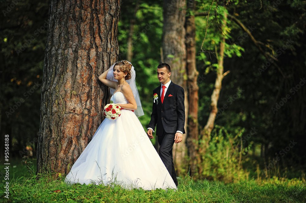 Young and gorgeus wedding couple on autumn forest