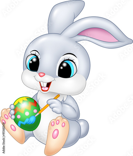 Cartoon funny Easter Bunny painting an egg